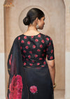 The stylish back of the Vanya Sarees designer blouse, showing the all-over pink floral butti print on a black base.