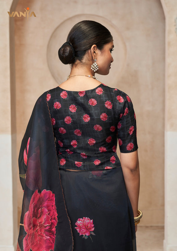 The stylish back of the Vanya Sarees designer blouse, showing the all-over pink floral butti print on a black base.