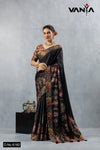 A full-length view of the model in Vanya Sarees' artistic black silk saree with a vibrant Kalamkari-style folk art print.