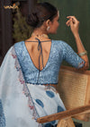 The stylish deep V-back of the printed designer blouse from Vanya Sarees, shown with the embroidered border of the blue saree.