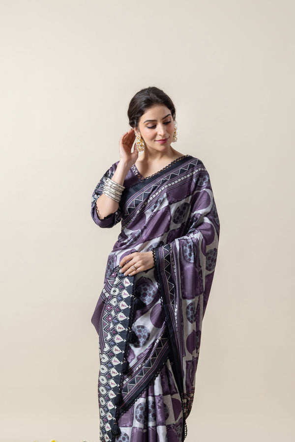 Side profile of a model adjusting her hair while wearing the Vanya designer crepe silk saree, highlighting the earring and sleeve design.