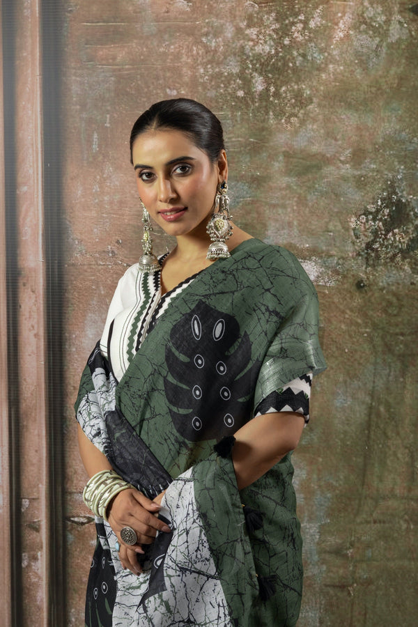 A portrait shot of the model in a Vanya Sarees green printed saree, showing the artistic design and matching designer blouse.