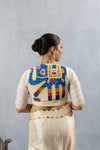 The stunning handcrafted elephant appliqué on the back of the off-white designer blouse from Vanya Sarees.