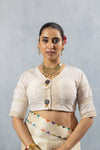 A clear front view of the Vanya Sarees readymade designer blouse in off-white, showing the V-neck and lace details.