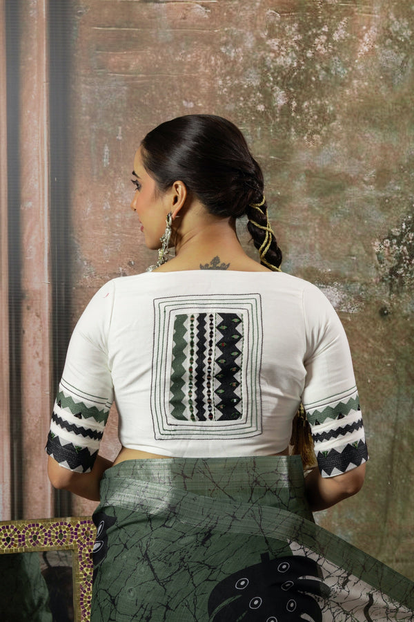 The stunning statement back of the designer blouse from Vanya Sarees, featuring intricate geometric and tribal-inspired appliqué work.