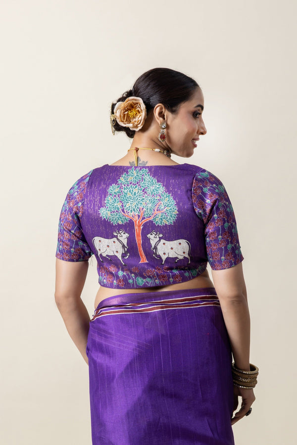 The stunning statement back of the designer blouse from Vanya Sarees, featuring a Pichwai-style print of sacred cows under the Tree of Life.