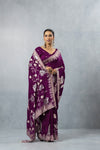 Elegant full-length view of a model wearing the Vanya plum purple designer saree, highlighting the rich pallu and contemporary style for party wear.
