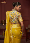 The stunning back view of the Vanya Sarees designer blouse, showcasing the rich multi-color floral print and modern shirt collar.