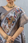 A detailed close-up of the pallu of the Vanya Sarees grey Chanderi saree, showing the intricate folk art print with embroidery highlights.