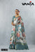 Vanya full-length view of the model standing, showcasing the entire drape and teal border of the Water Lily print saree.
