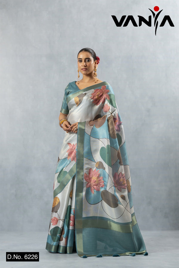 Vanya full-length view of the model standing, showcasing the entire drape and teal border of the Water Lily print saree.