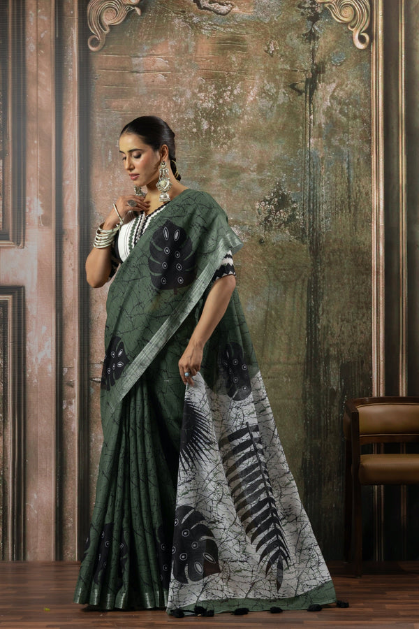 A stylish side profile of the model in the Vanya Sarees green and white printed saree, highlighting the designer blouse and pallu.