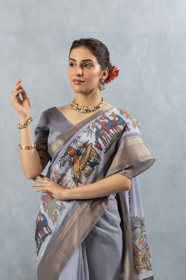 A close-up of the model in a Vanya Sarees grey Chanderi saree, highlighting the artistic print on the shoulder and the rich zari border.