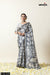 A full-length view of the model wearing Vanya Sarees' elegant grey and off-white elephant print Modal silk saree.