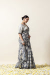 An elegant side profile of the model in the Vanya Sarees grey elephant print saree, showcasing its fluid drape.