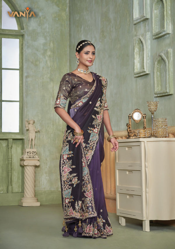 An elegant standing pose of the model showcasing the complete designer look of the Vanya Sarees heavy embroidered purple ombre saree.