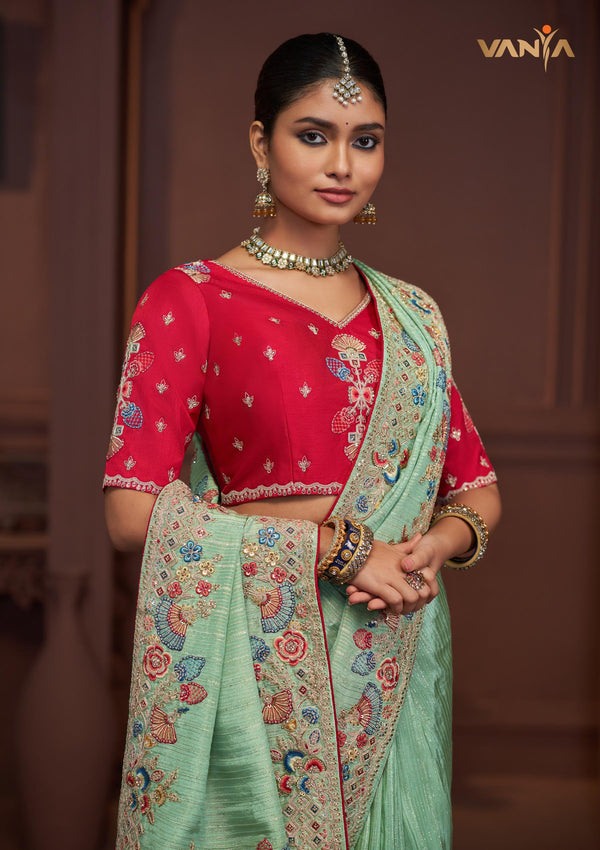 A beautiful close-up of the model in a Vanya Sarees saree, highlighting the rich, multi-color floral and peacock embroidery.