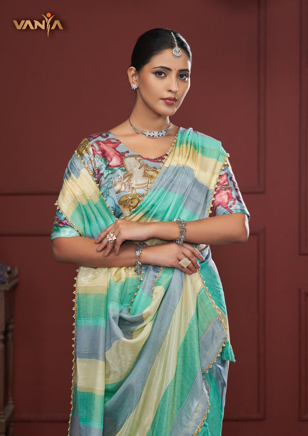 A beautiful close-up of the model in a Vanya Sarees saree, highlighting the rich, painterly Kalamkari-style print on the designer blouse.
