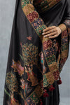 A detailed close-up of the pallu of the Vanya Sarees black silk saree, showing the intricate Kalamkari-style print of the Tree of Life.