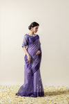 An elegant side profile of the model wearing the Vanya Sarees lavender Kota Doria saree, showcasing its beautiful drape.