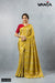 A full-length view of the model in Vanya Sarees' vibrant lime yellow and gold striped Katan Banarasi silk saree.