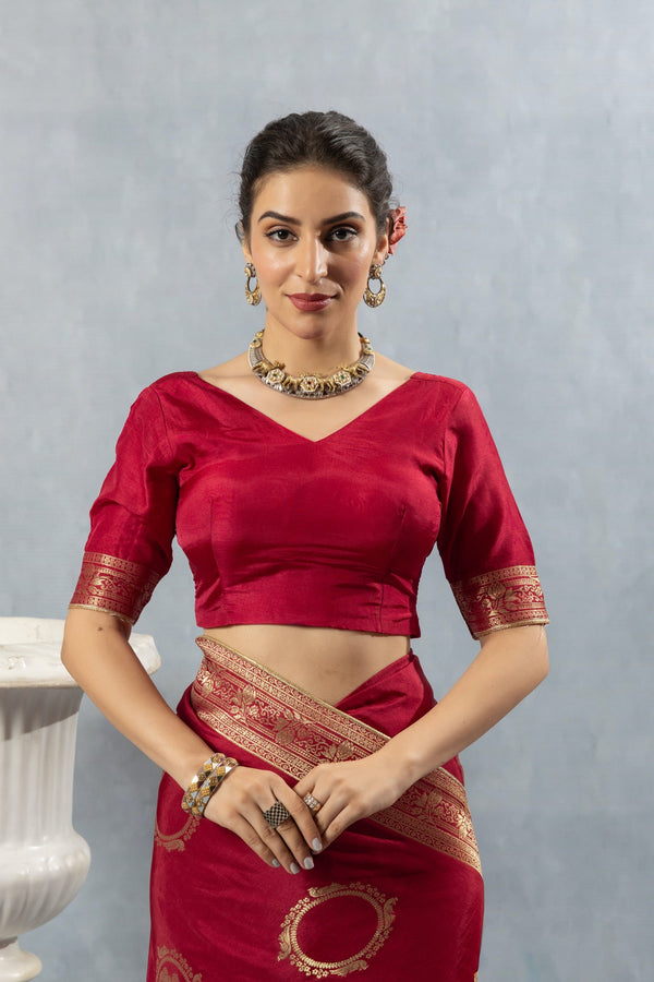 Close-up of Vanya's Maroon Art Silk V-Neck Blouse with gold zari woven trim on the sleeve cuff.