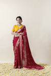 A full-length pose of the model showcasing the complete wedding-ready look of the Vanya Sarees maroon georgette saree.