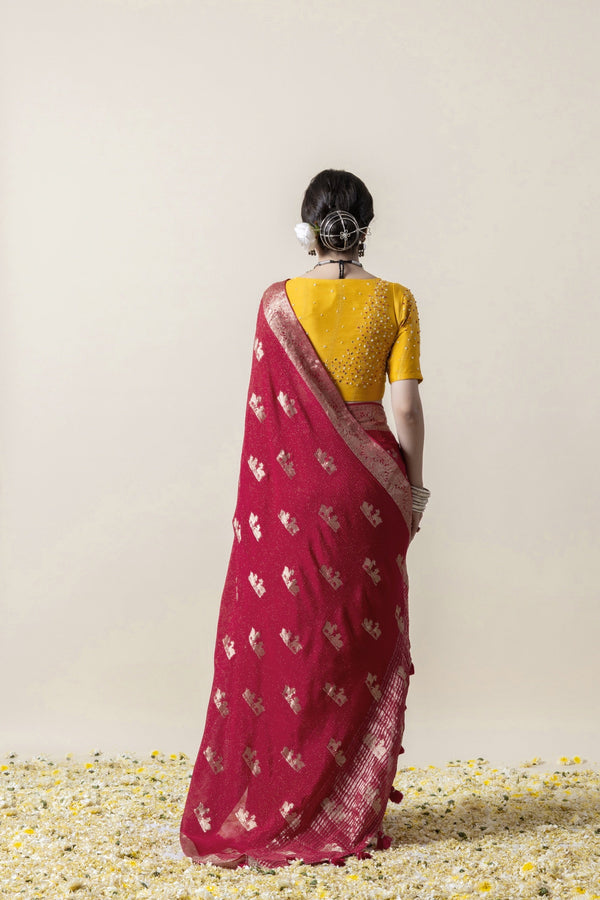 A full back view of the model in the Vanya Sarees ensemble, displaying the woven zari buttis on the pallu and the embellished yellow blouse.