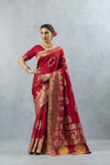 Vanya Maroon Saree side profile pose, showcasing the elegant drape and the heavy gold zari weave on the border and skirt.