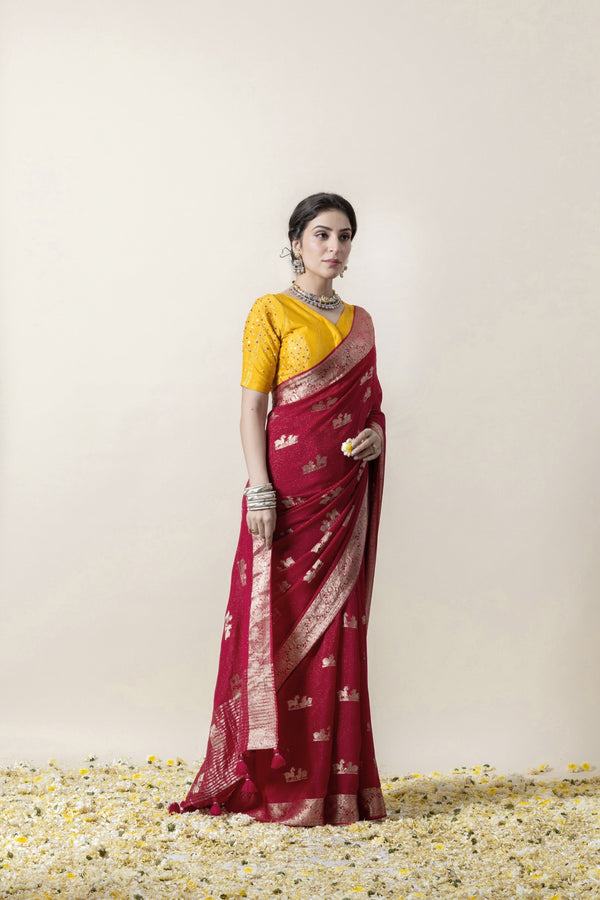 An elegant side profile of the model in the Vanya Sarees maroon woven georgette saree, showing its rich drape and Banarasi border.