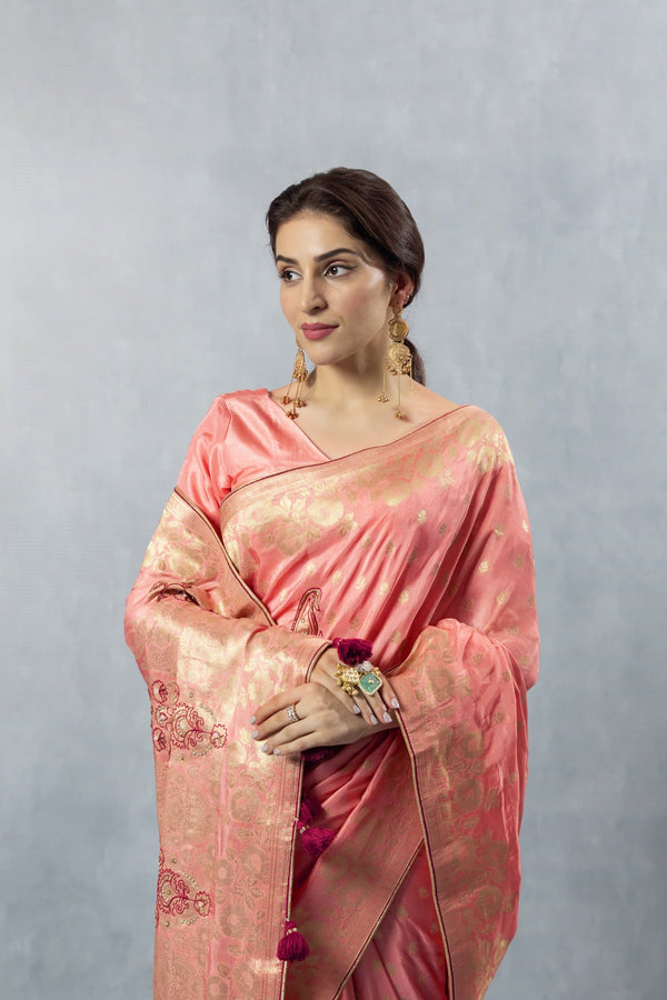 Upper body close-up of Vanya Peach Saree, focusing on the sheer luminosity of the fabric and the statement gold earrings.