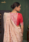 The elegant back view of the Vanya Sarees ensemble, showing the red designer blouse with its brocade panel against the pink Banarasi saree.