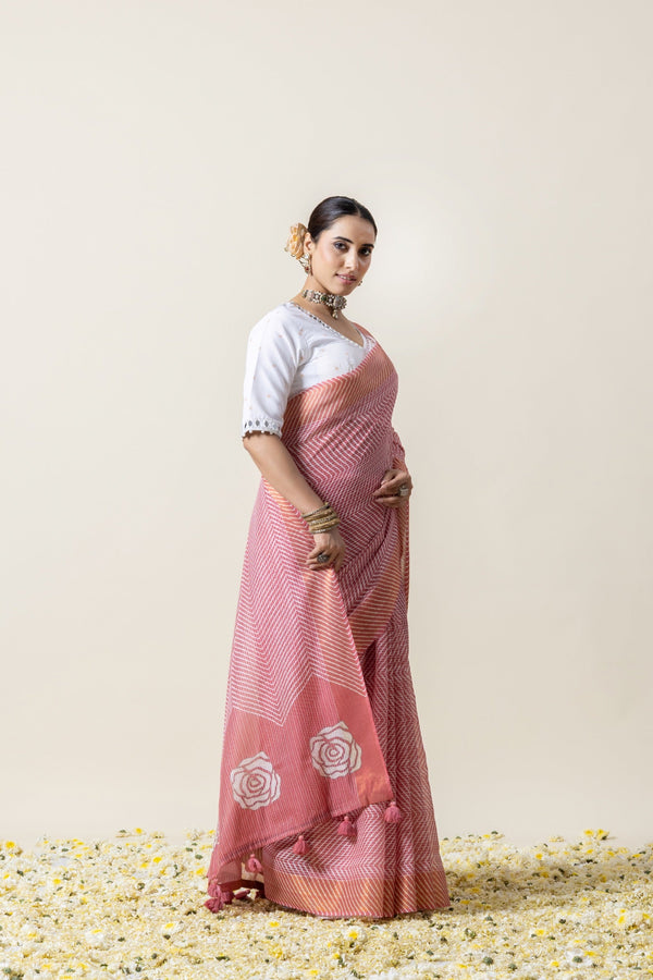 An elegant side profile of the model in the Vanya Sarees pink Leheriya and rose print saree, perfect for a day wedding.