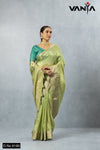 A full-length view of the model in Vanya Sarees' elegant pistachio green tissue silk saree with a gold Banarasi border.