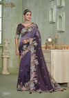 A full-length view of the model in Vanya Sarees' magnificent purple ombre silk saree with a heavy, multi-color embroidered border.