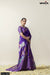 A full-length view of the model in Vanya Sarees' artistic purple Tussar silk saree with a traditional Pichwai print.