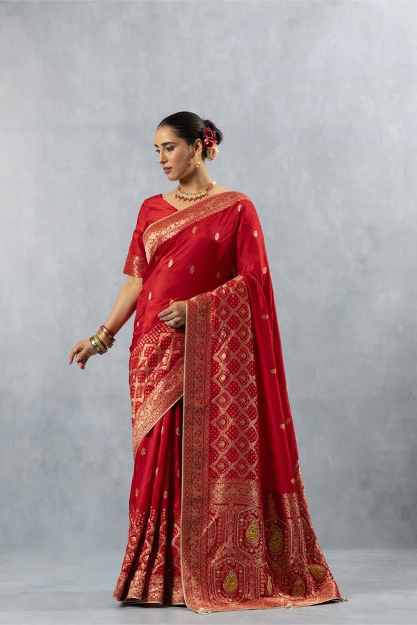 Vanya Red Art Silk saree side pose, showing the fall of the fabric and the geometric weave on the lower skirt.