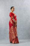 Vanya Red Saree profile view, clearly illustrating the heavy gold brocade pallu draped over the shoulder.