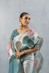 Vanya Digital Print saree close-up, showing abstract lotus detail, shimmering fabric texture, and model's expression.