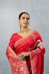 Upper body close-up of Vanya Red Saree, focusing on the striped pallu near the shoulder and the embroidered blouse sleeve.