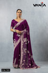 Official catalogue image for Vanya Sarees (D.No 7251) featuring a model in a plum purple satin silk saree with silver swan weaving.