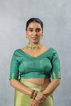 A clear front view of the Vanya Sarees readymade designer blouse in teal green, showcasing the modern, wide V-neckline.