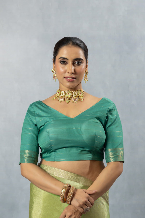 A clear front view of the Vanya Sarees readymade designer blouse in teal green, showcasing the modern, wide V-neckline.