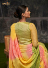 The stylish back of the Vanya Sarees designer blouse, showing the rich yellow brocade panel against the tricolor ombre saree.