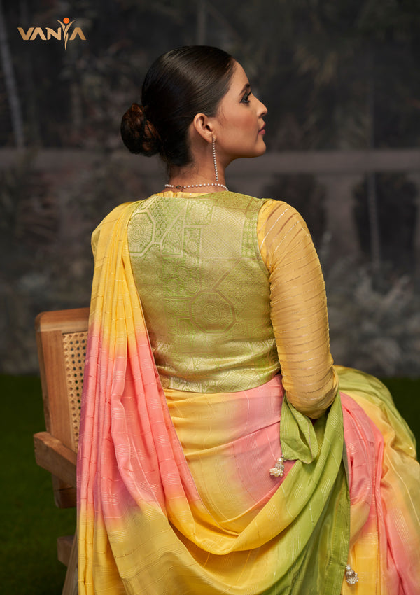 The stylish back of the Vanya Sarees designer blouse, showing the rich yellow brocade panel against the tricolor ombre saree.