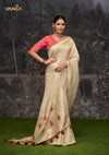 An elegant standing pose of the model showcasing the complete designer look of the Vanya Sarees off-white Banarasi saree and red blouse.