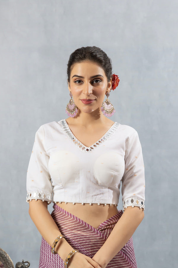 A clear front view of the readymade white designer blouse from Vanya Sarees, showing the intricate mirror work on the V-neckline.