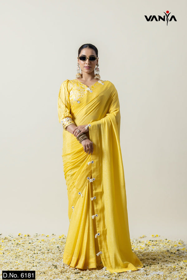 A full front view of the model in Vanya Sarees' unique yellow saree, showcasing the handcrafted bow border and designer blouse.