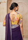 The stylish designer back of the yellow floral print blouse from Vanya Sarees, featuring a dori tie-up and tassel.