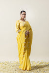 A full-length pose of the model in the Vanya Sarees yellow designer saree, perfect for a Haldi ceremony or day wedding.
